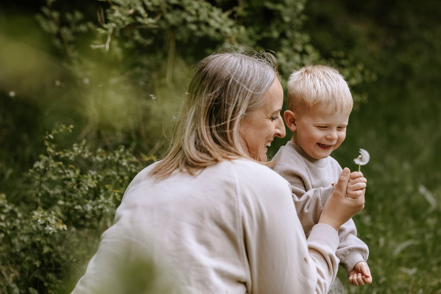 Intimate outdoor moment between parent and child enjoying nature together.