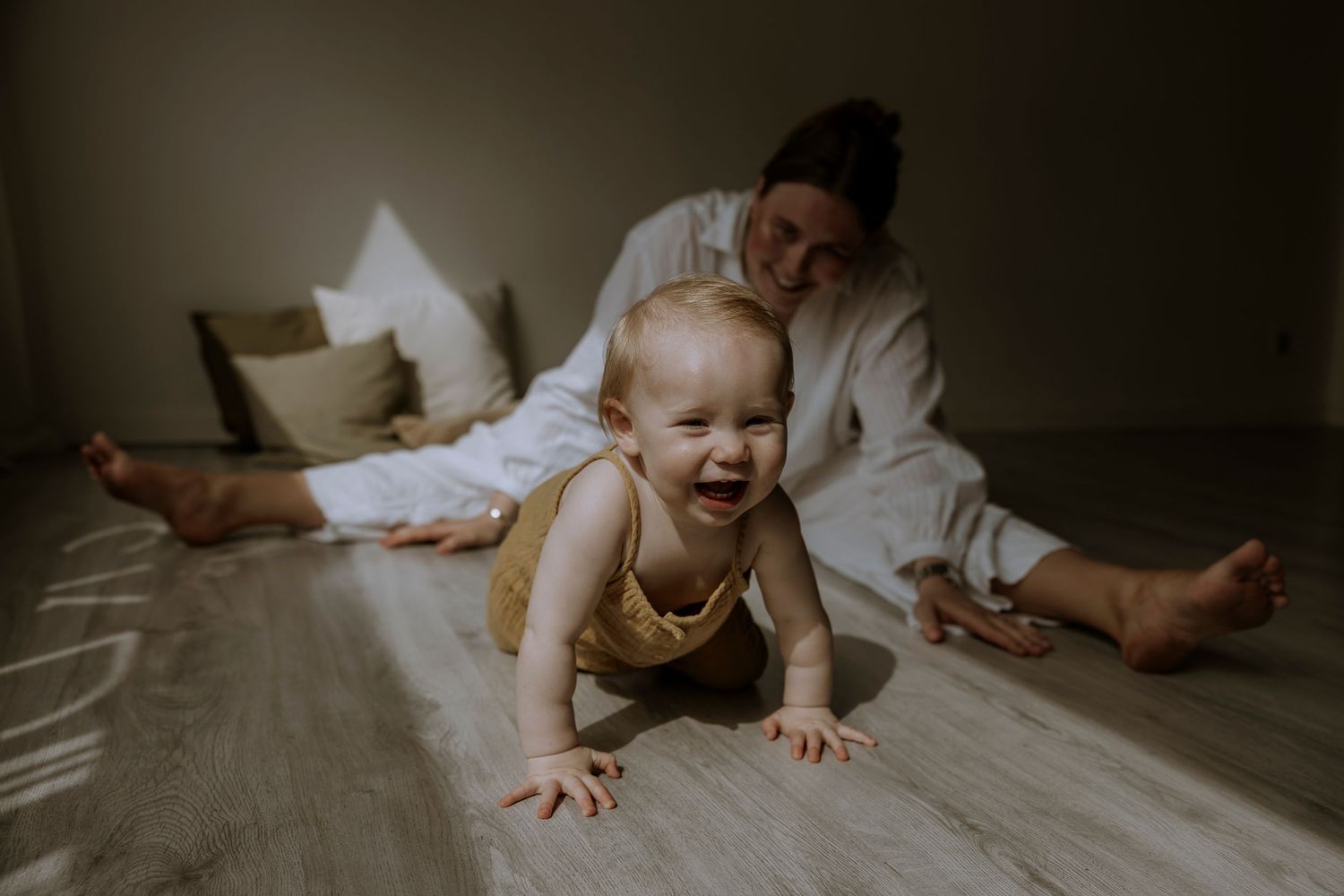 A playful moment captured in natural light showing pure happiness and connection.