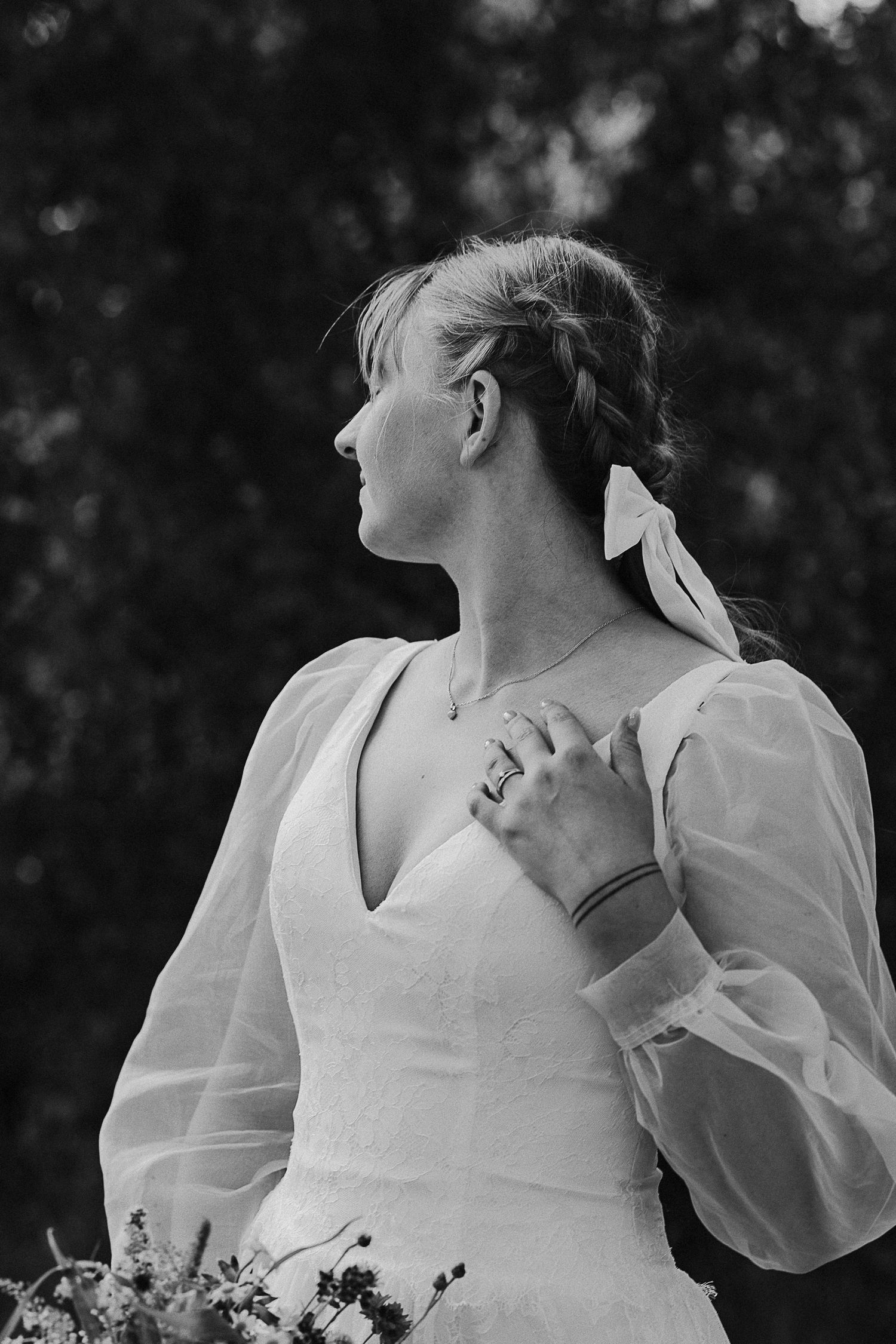 Black and white portrait of a bride in a classic white dress with puff sleeves.