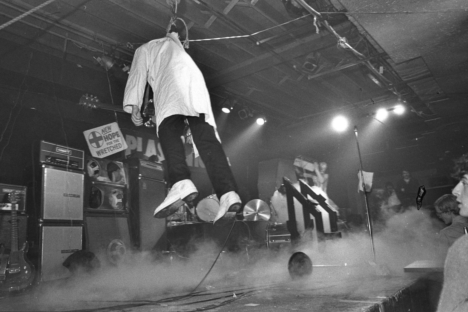 Black and white concert photography showing performers on stage with dramatic lighting.