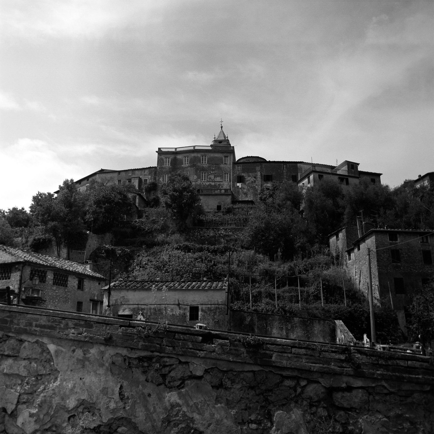 Panoramic hillside view of a Mediterranean village with traditional architecture.