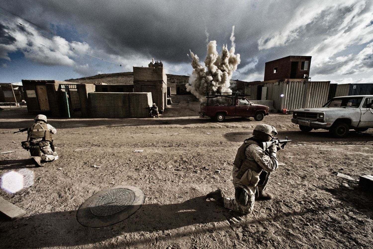 Military personnel conducting tactical exercises in an arid training environment.