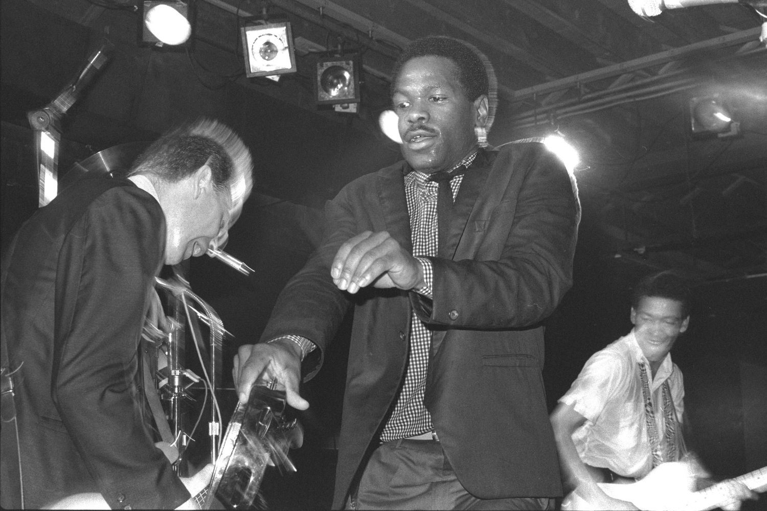 Concert performers interact with audience members during a high-energy live music show.