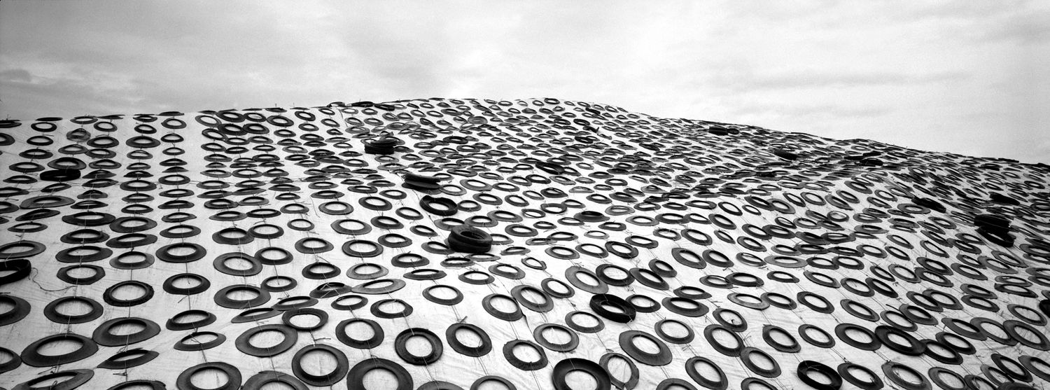 Black and white pattern of repeating circles and ovals creates an abstract geometric design across the surface.