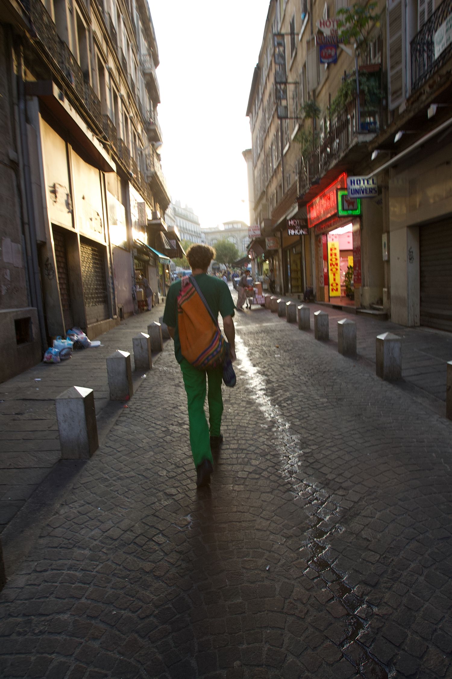 Sequence of images showing a cobblestone street at sunset with shops and buildings.