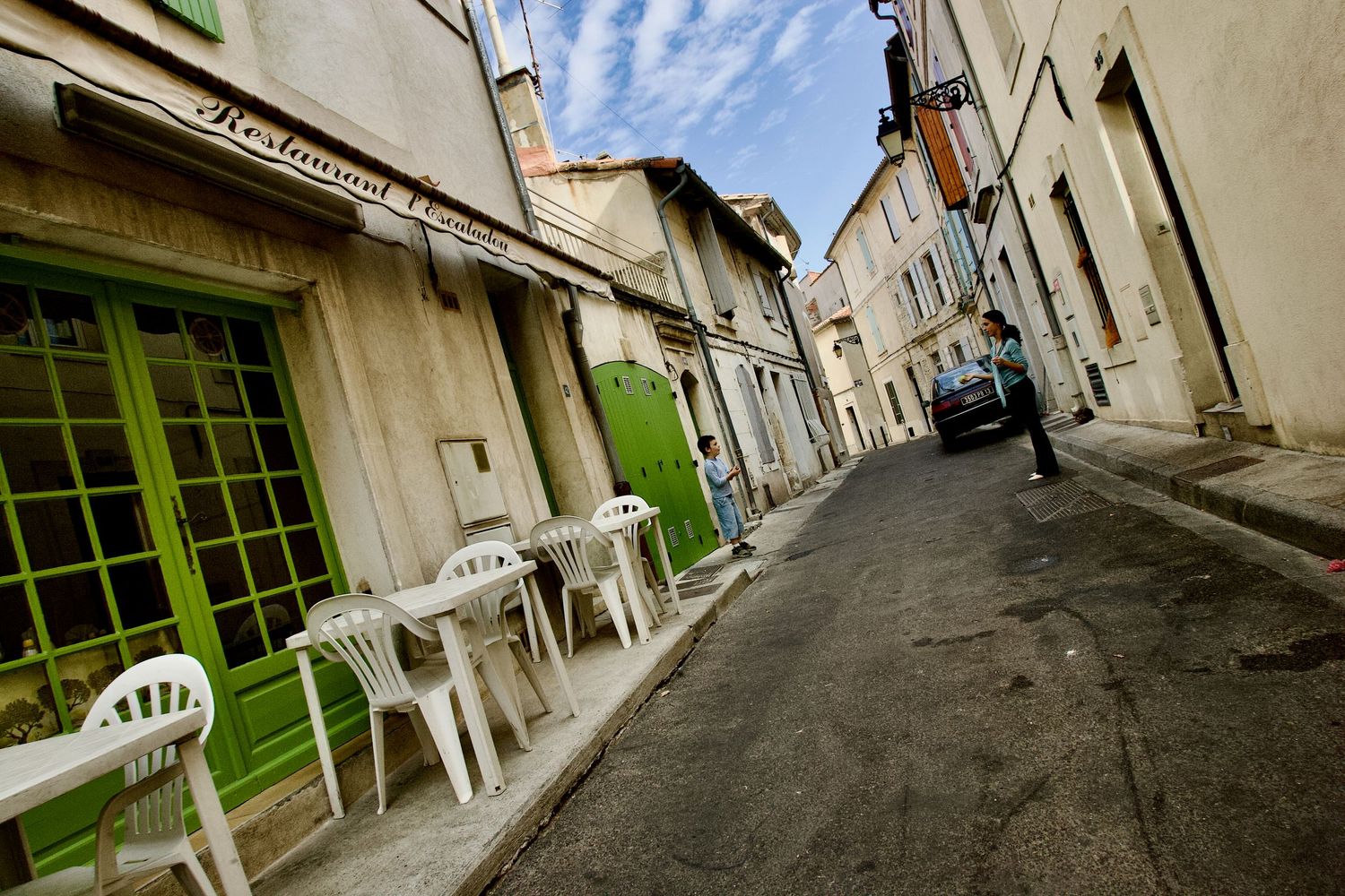 Narrow cobblestone streets and historic buildings line an old European town alleyway.