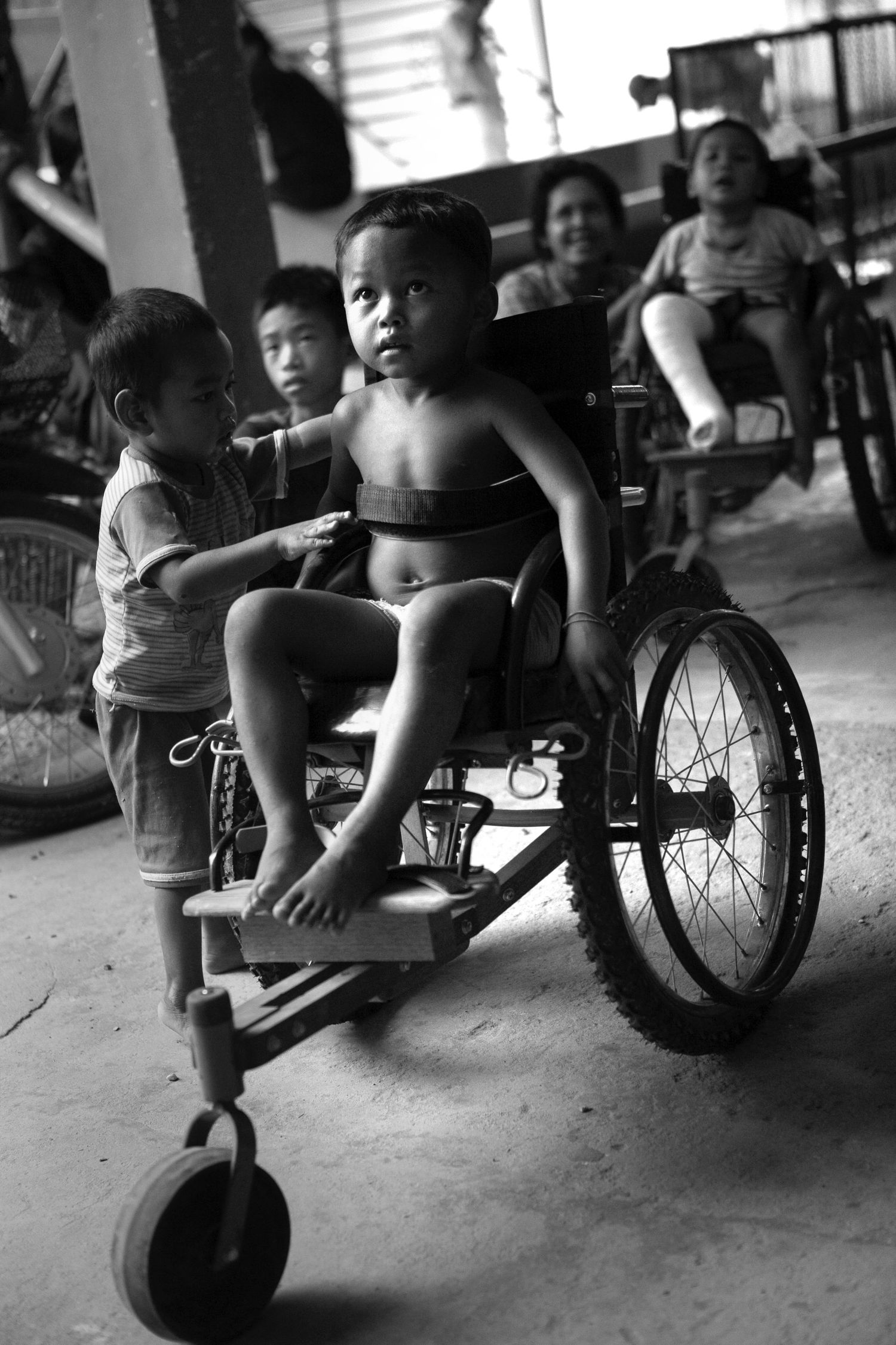 Several wheelchairs shown in black and white photography at an indoor facility.