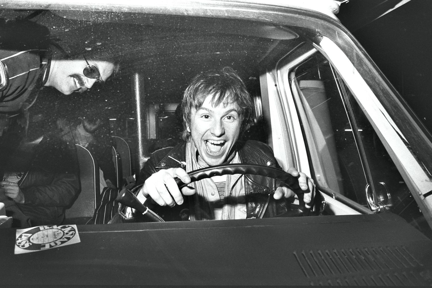 Vintage black and white photographs showing people in cars at night.