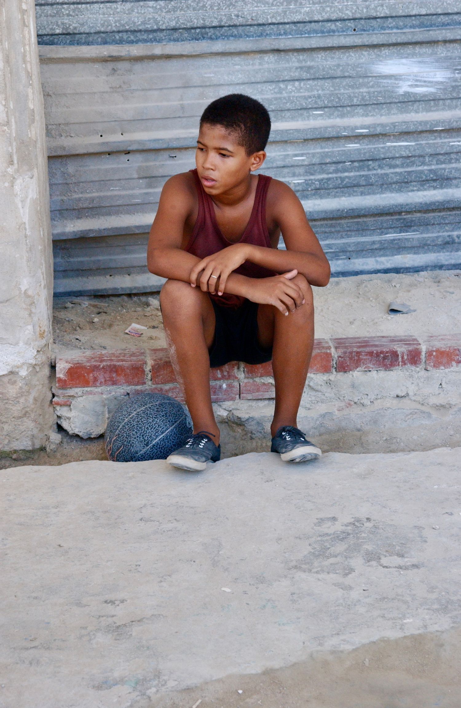 Cuban Kid Sitting Curb - Photograph by Richard D. Schoenberg