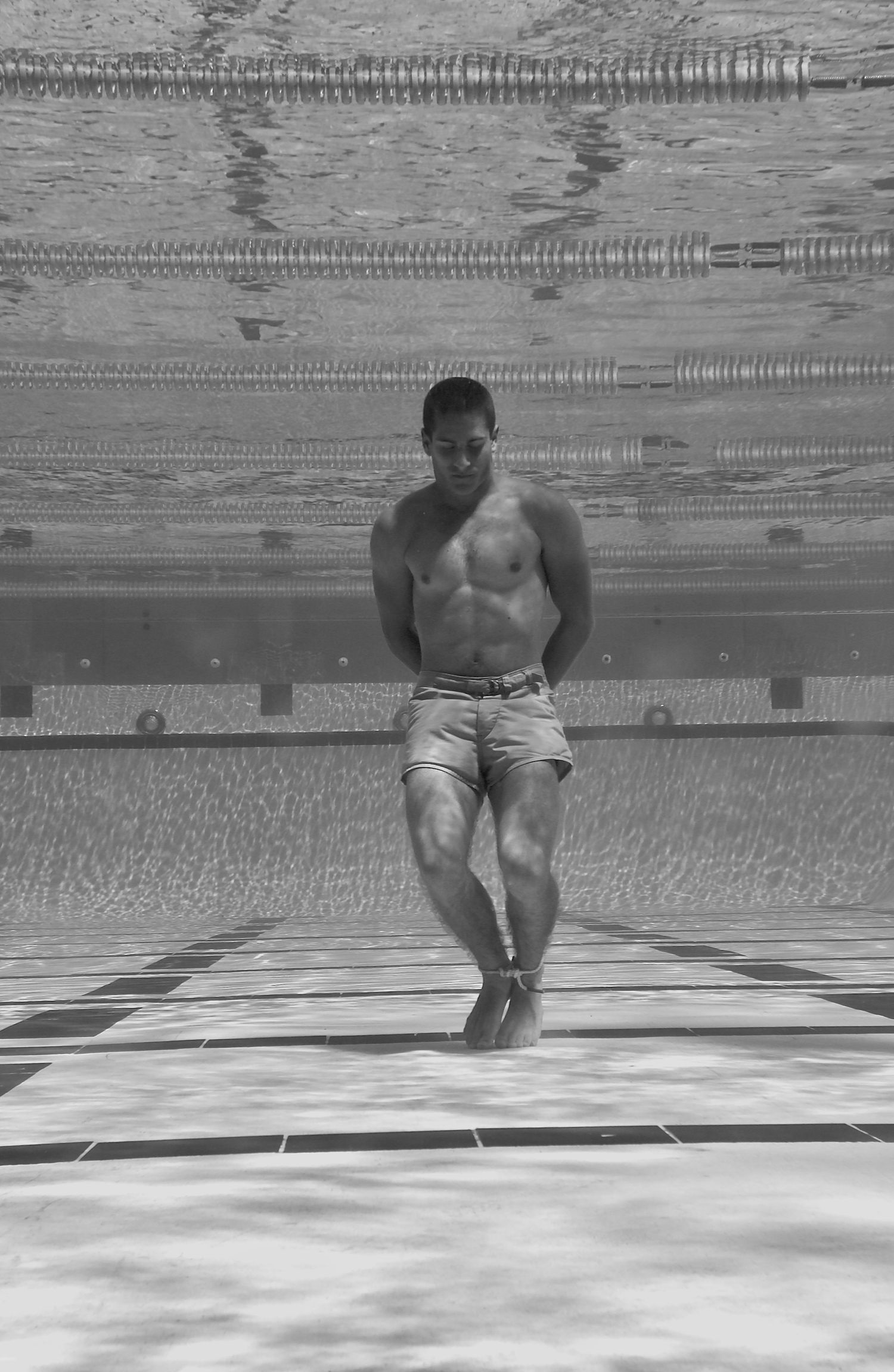 Underwater sequence of swimming motions captured beneath the surface of a pool.