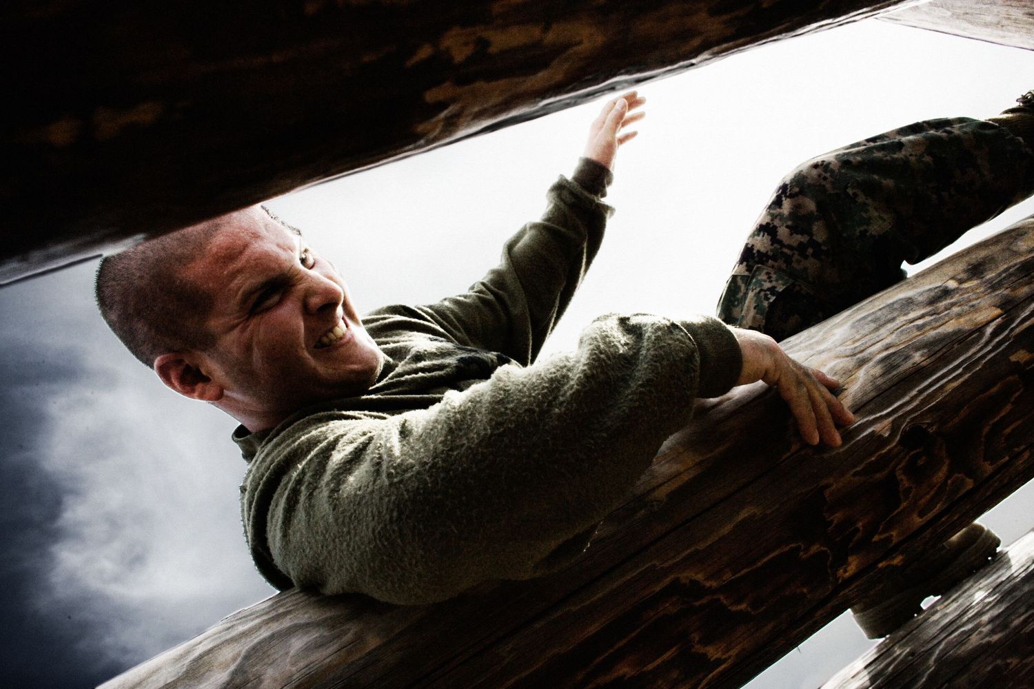 Special forces train in a dark tunnel-like environment practicing tactical maneuvers.