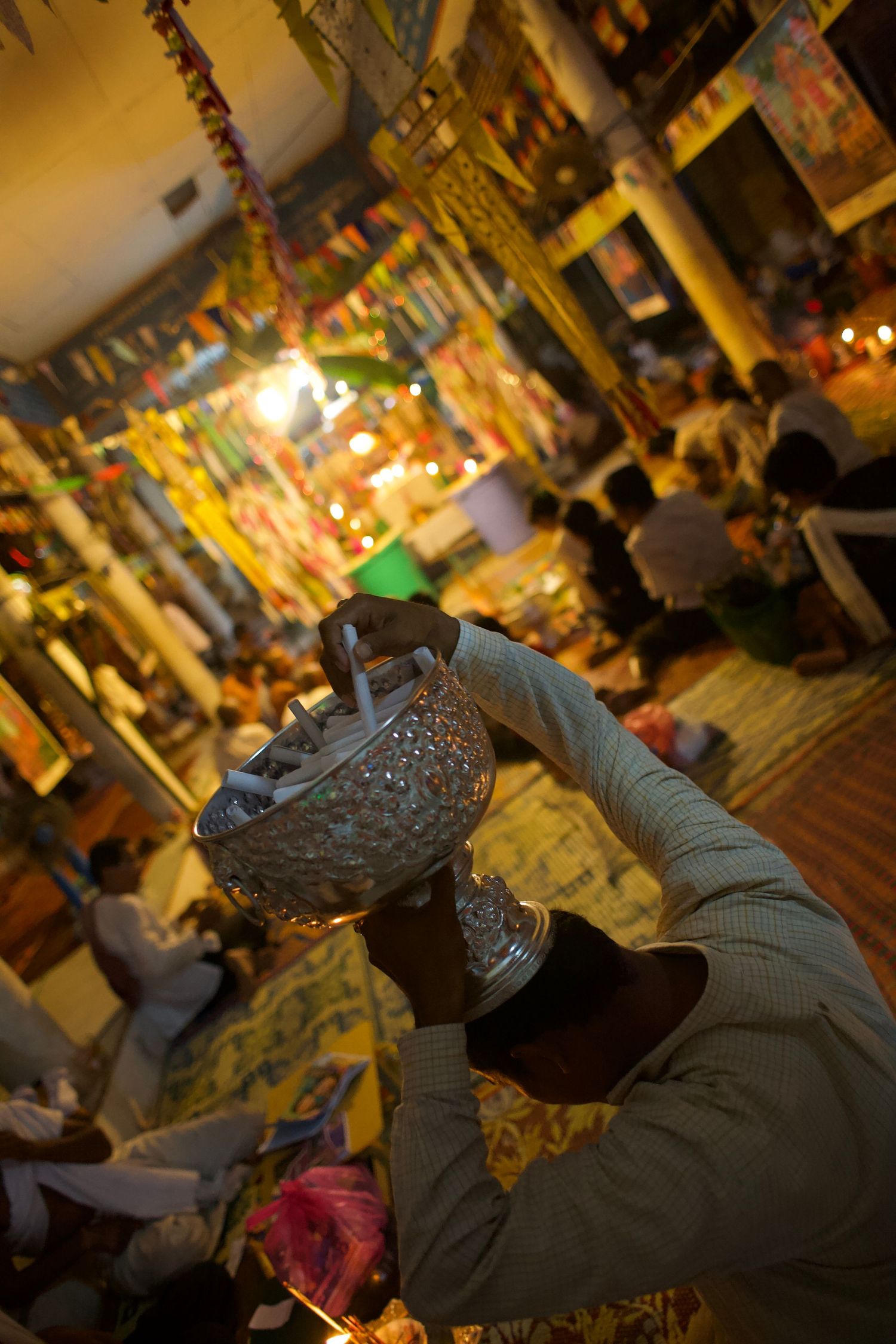 Atmospheric temple or shrine scene with incense and golden lighting.
