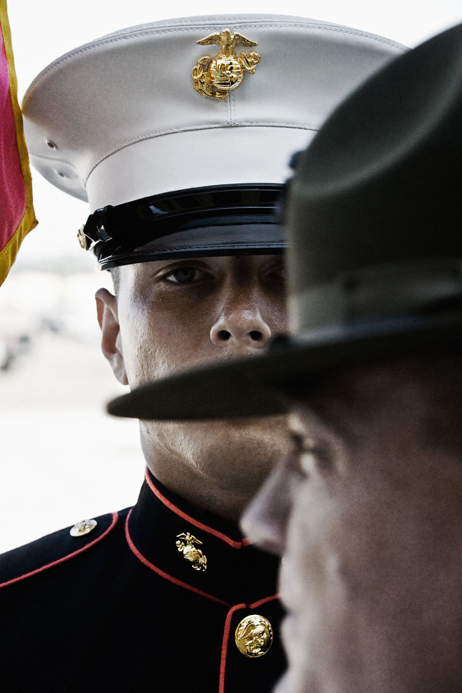 Marine Corps service members in dress uniforms standing at attention.