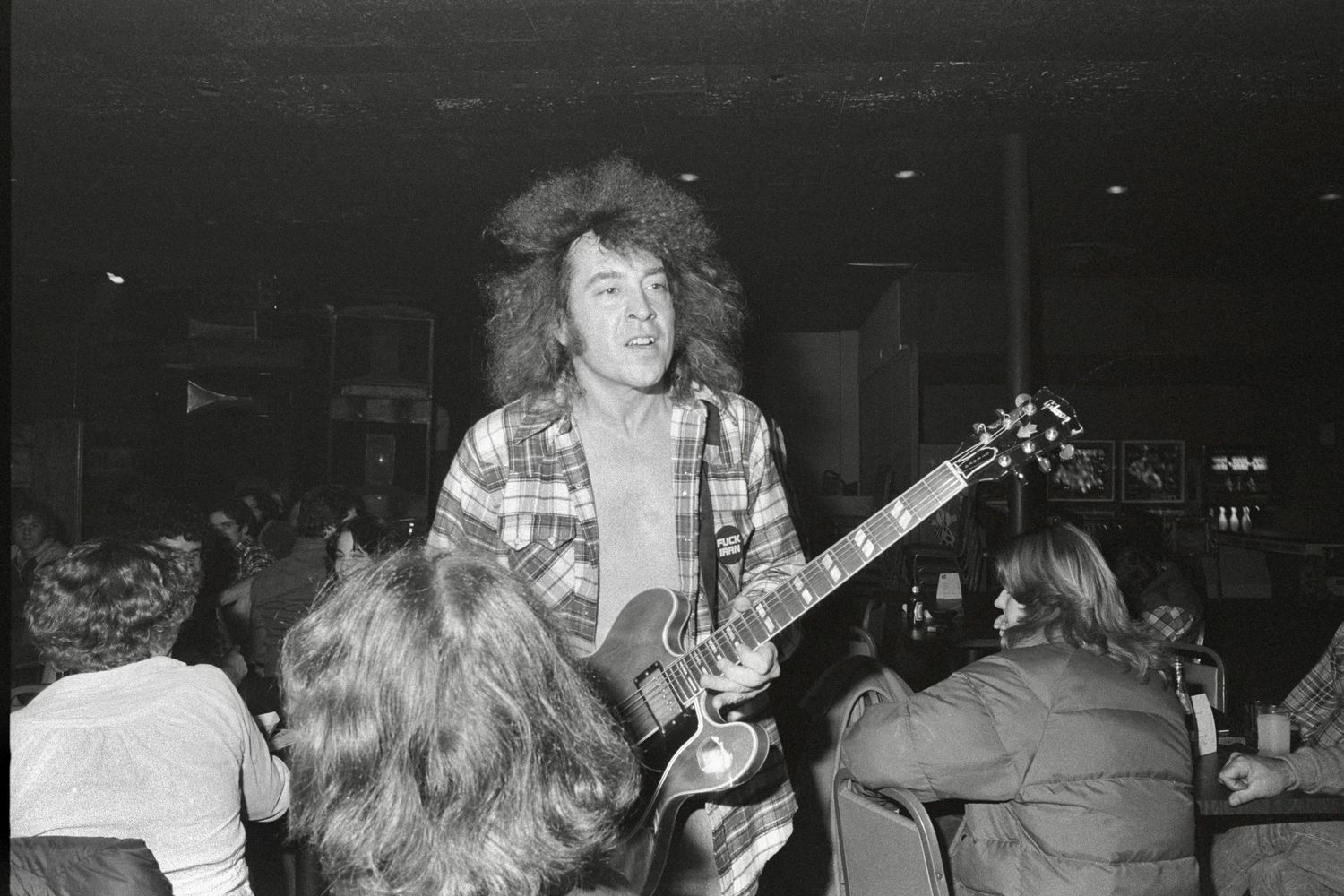 Black and white concert photographs show musicians performing energetically on stage in a dark venue.