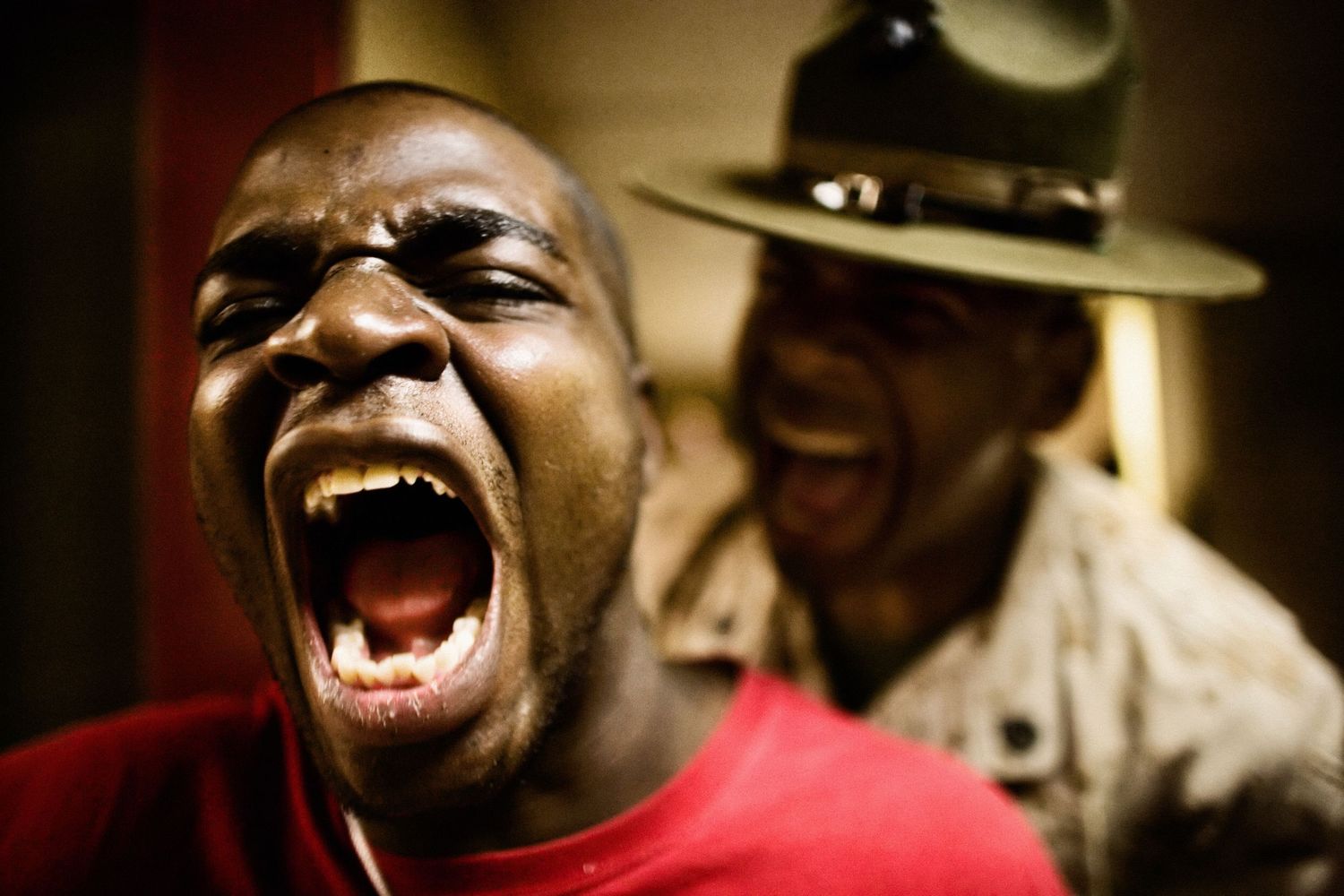 Close-up shots showing intense expressions during military training.