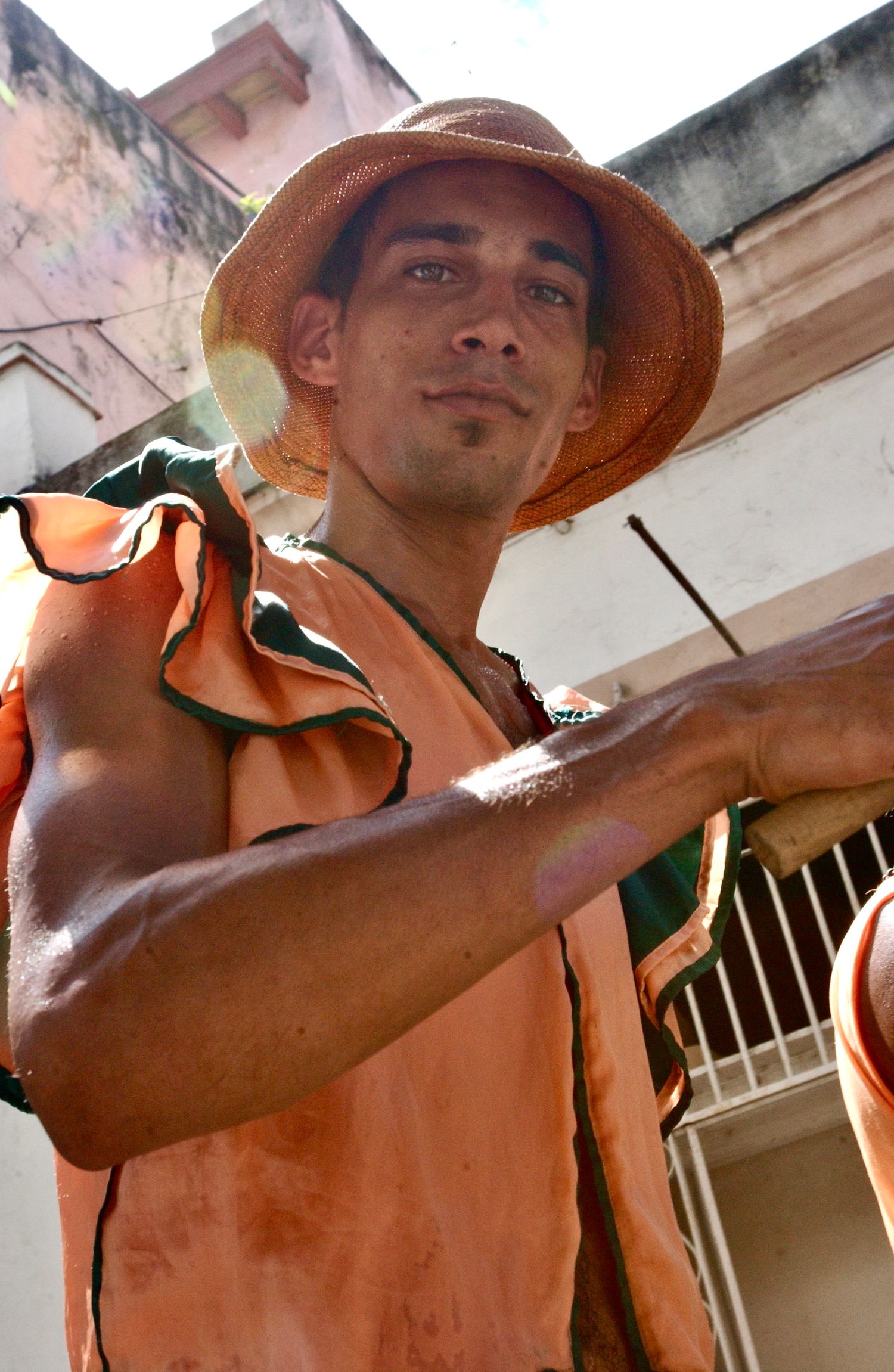 Cuban Man Looking straight into Camera - getting ready for festival  - Photograph by Richard D. Schoenberg