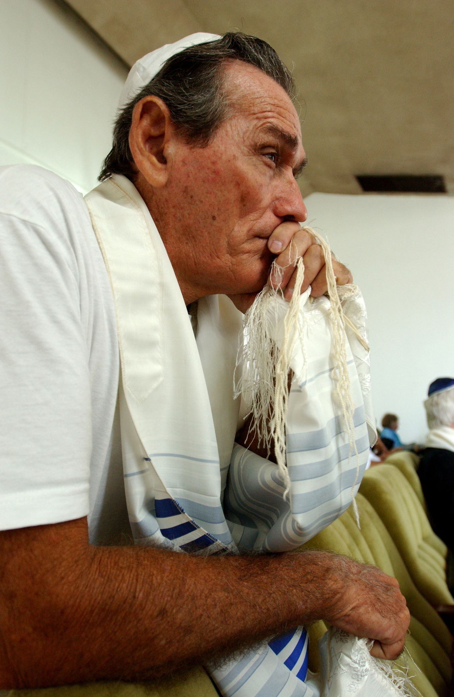Person in white clothing holding what appears to be a breathing mask or medical device.