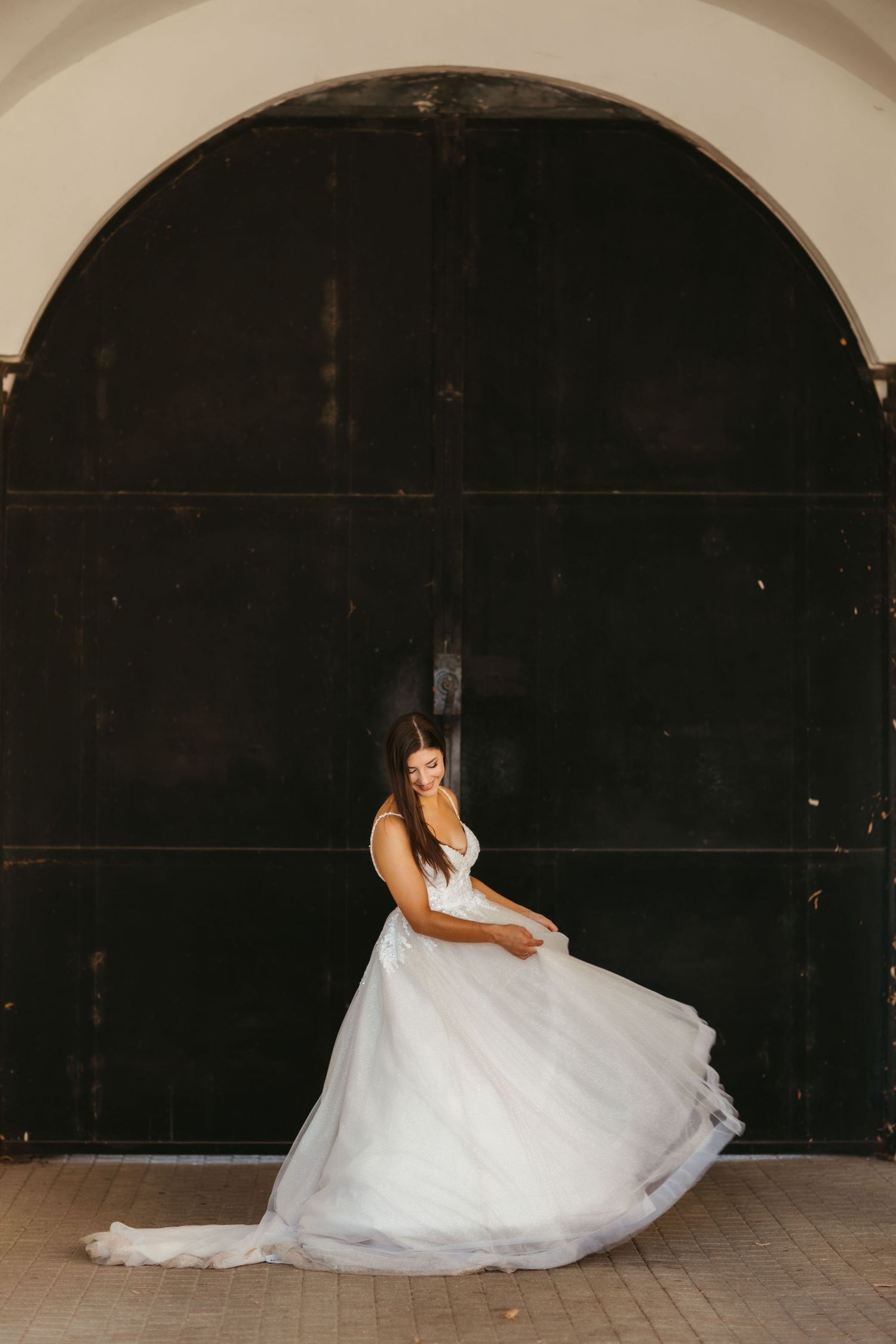 A sequence of wedding dress photos showing graceful movement and flow of a white gown against a dark background.