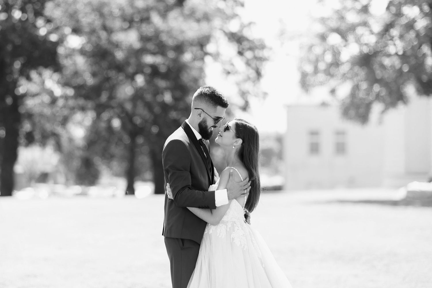 A beautiful black and white wedding photo collection showing romantic moments between newlyweds in outdoor settings.