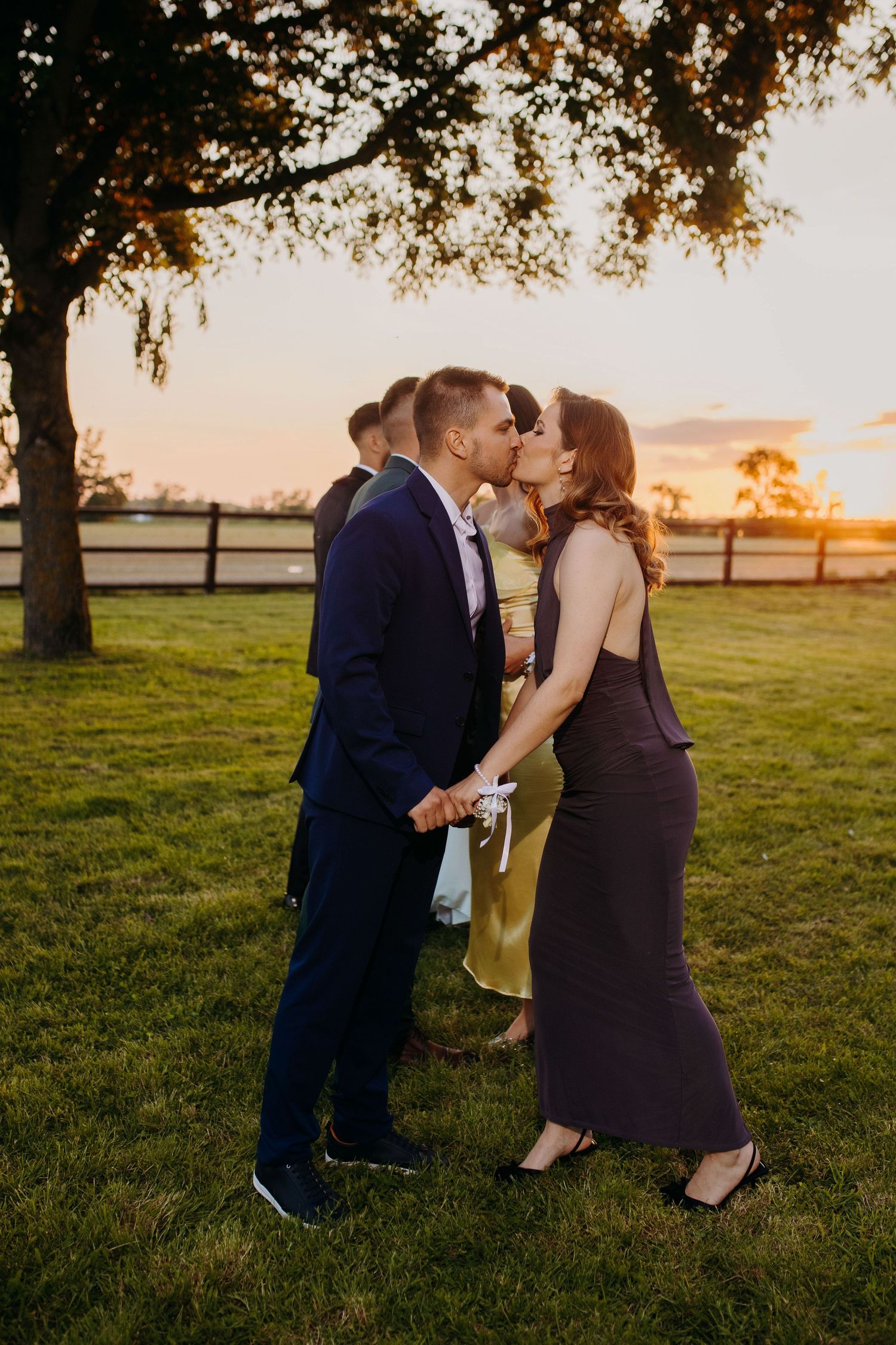 A couple shares intimate moments in a grassy field during golden hour sunset across multiple romantic shots.