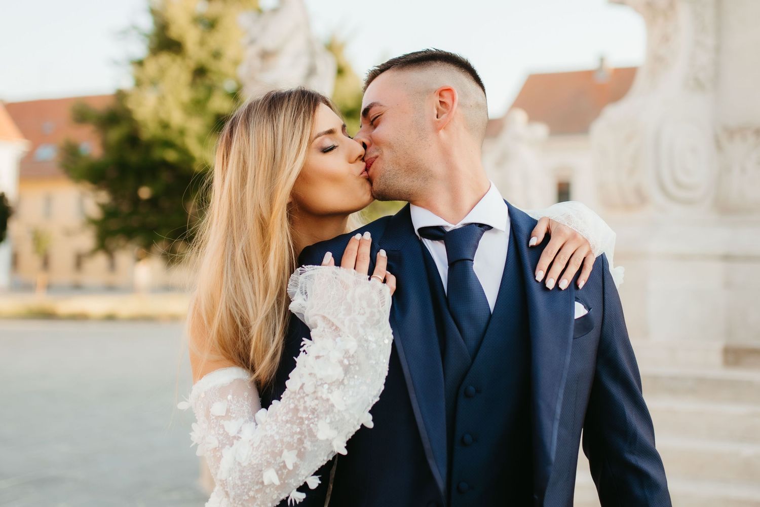 Intimate wedding portrait showing tender moment between couple in formal attire.