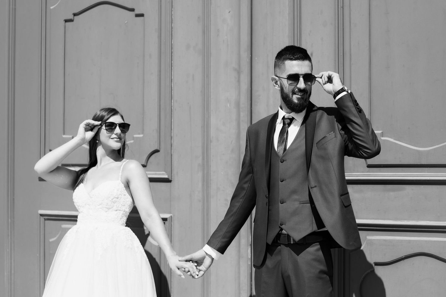 Wedding party having fun while posing and performing silly dance moves during an outdoor photo session.