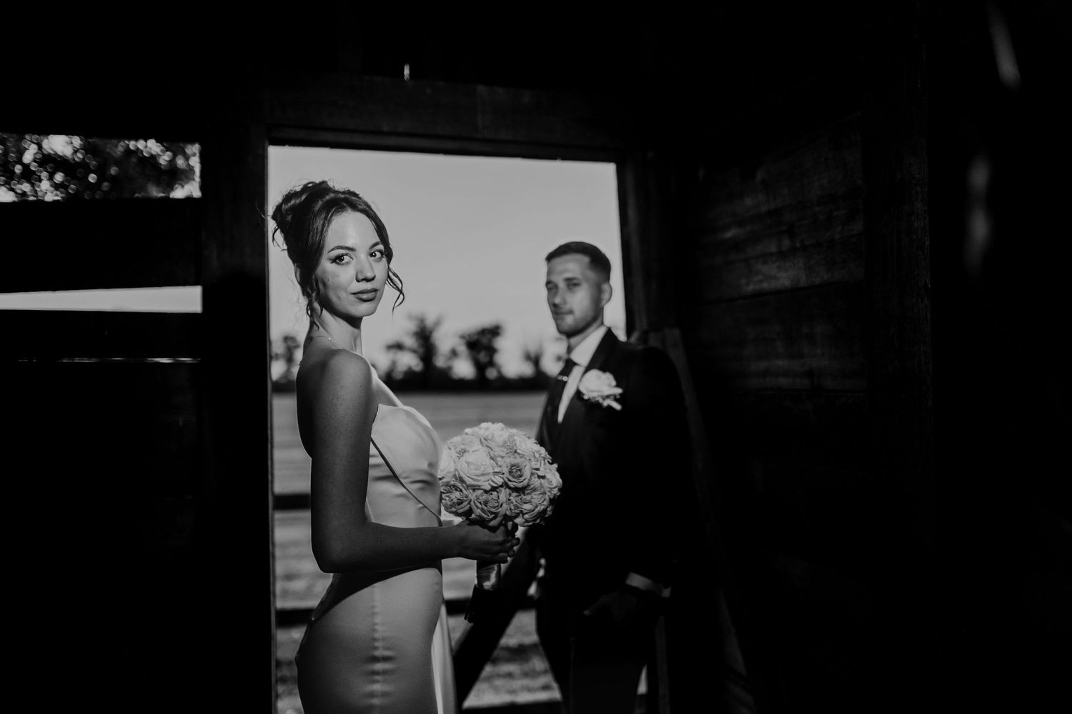 A collection of black and white wedding photography images showing various moments of celebration and preparation.
