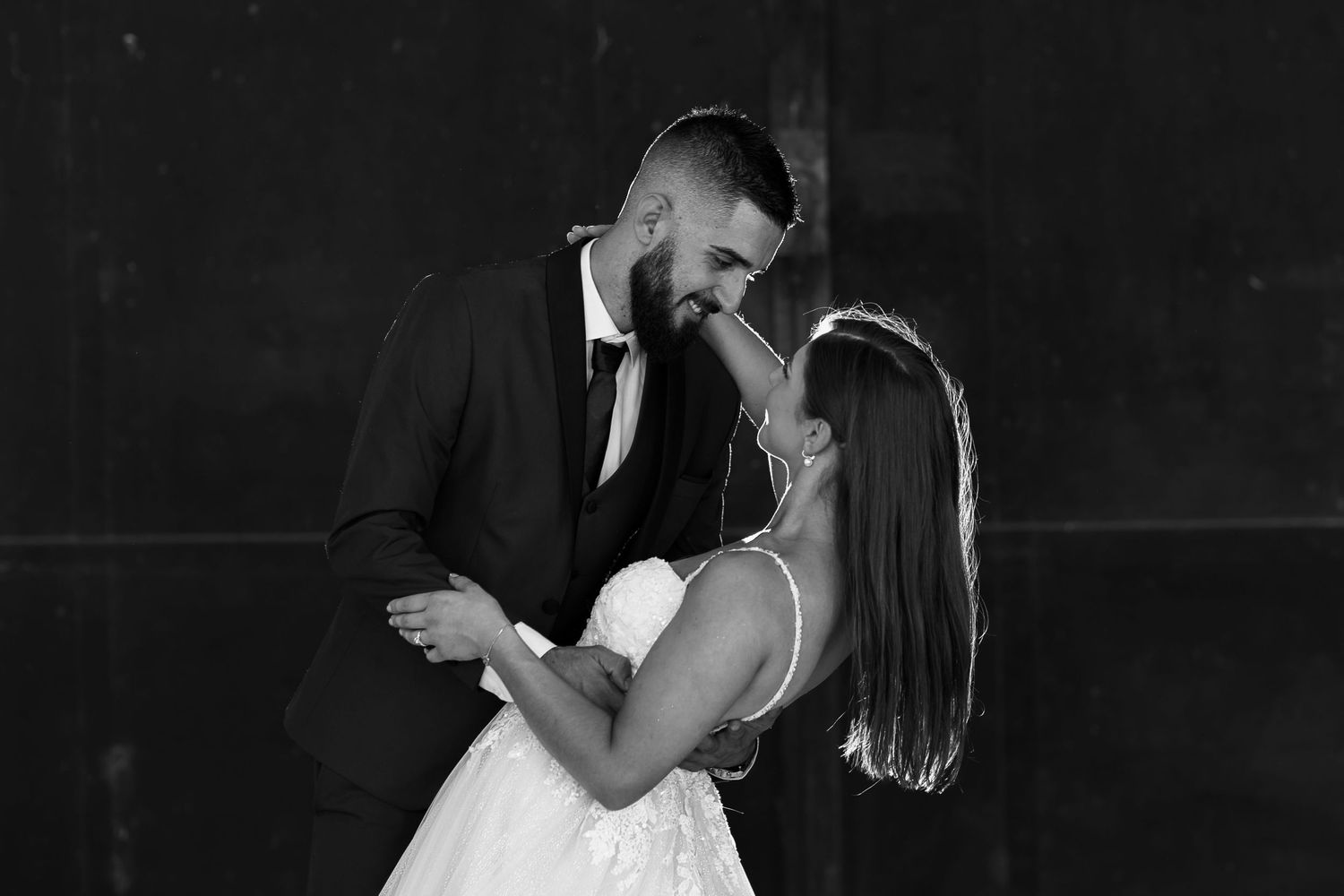 Three black and white photos of a couple dancing closely together in an intimate moment at their wedding.