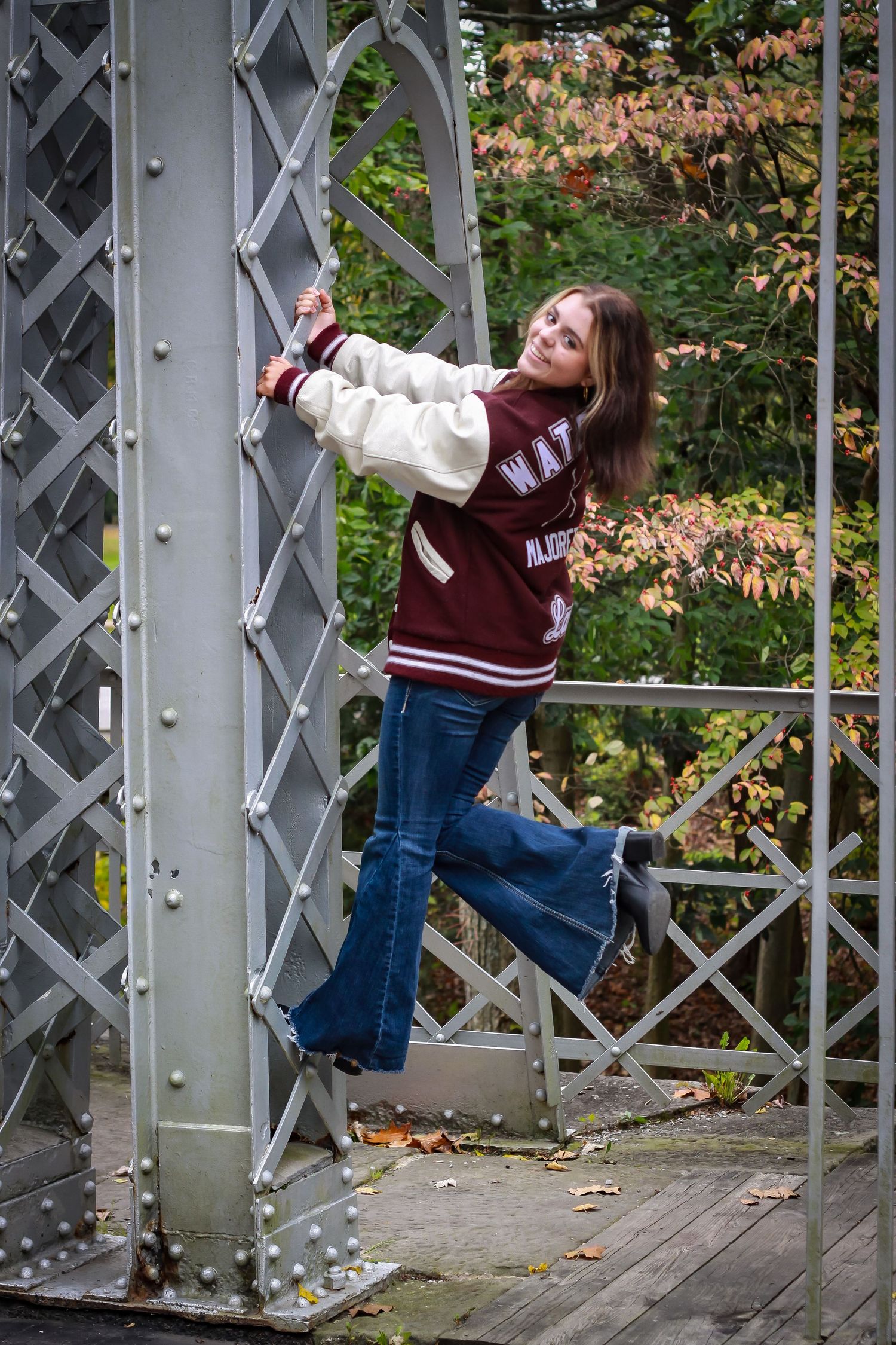 Senior session A confident and stylish senior portrait captured on a scenic suspension bridge—blending natural beauty with bold personality.