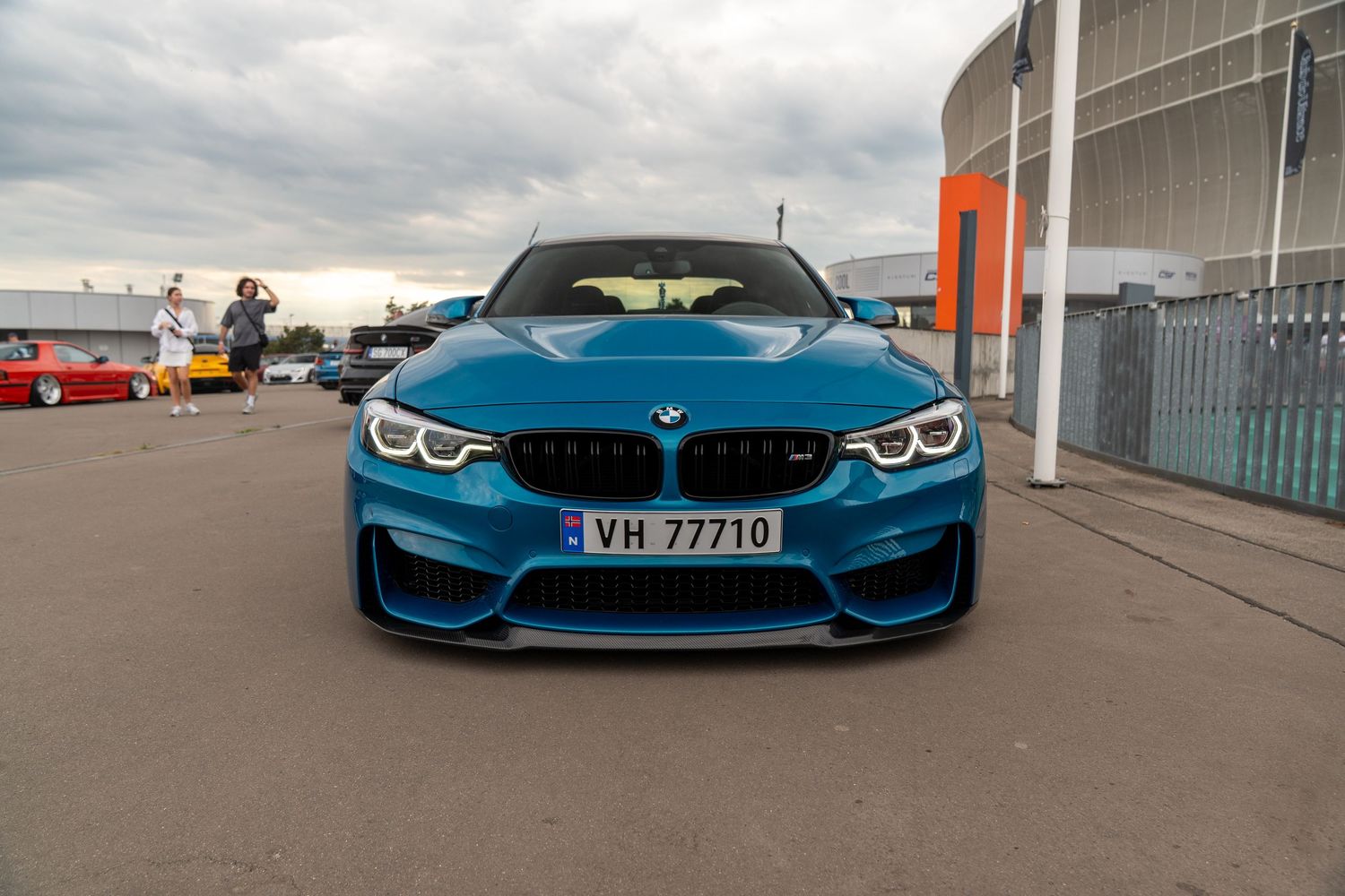 Collection of BMW M4 sports cars in various shades of blue and silver lined up outdoors.
