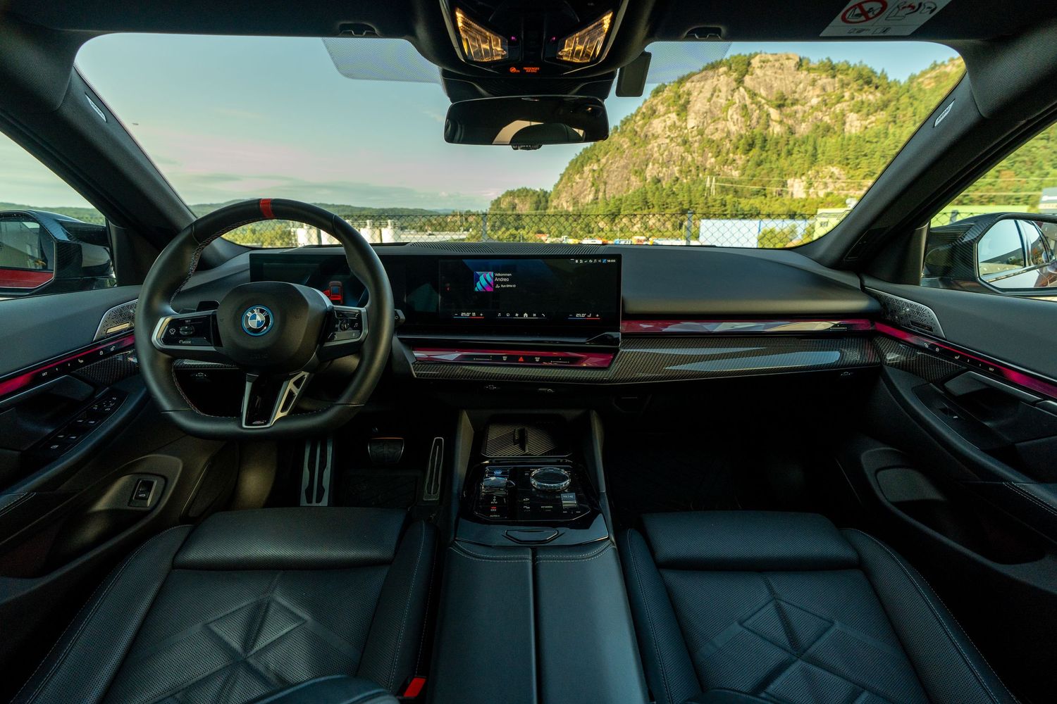 Modern BMW dashboard and interior featuring red accents and digital displays.