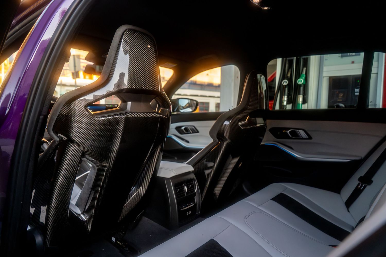 Interior view of modern car showing the instrument panel and dashboard lit up at night with ambient lighting.