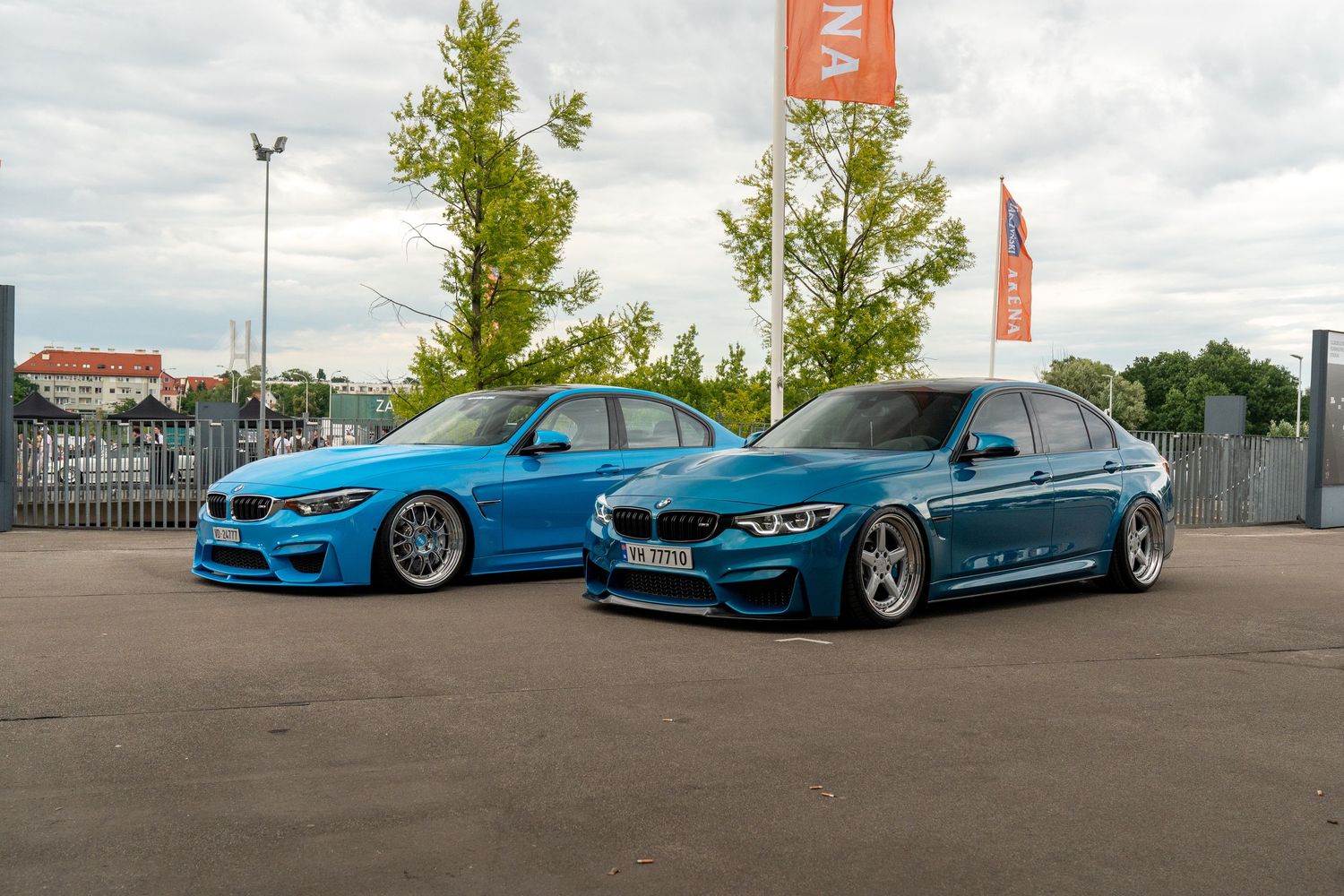 Blue BMW M series cars lined up in a parking lot.