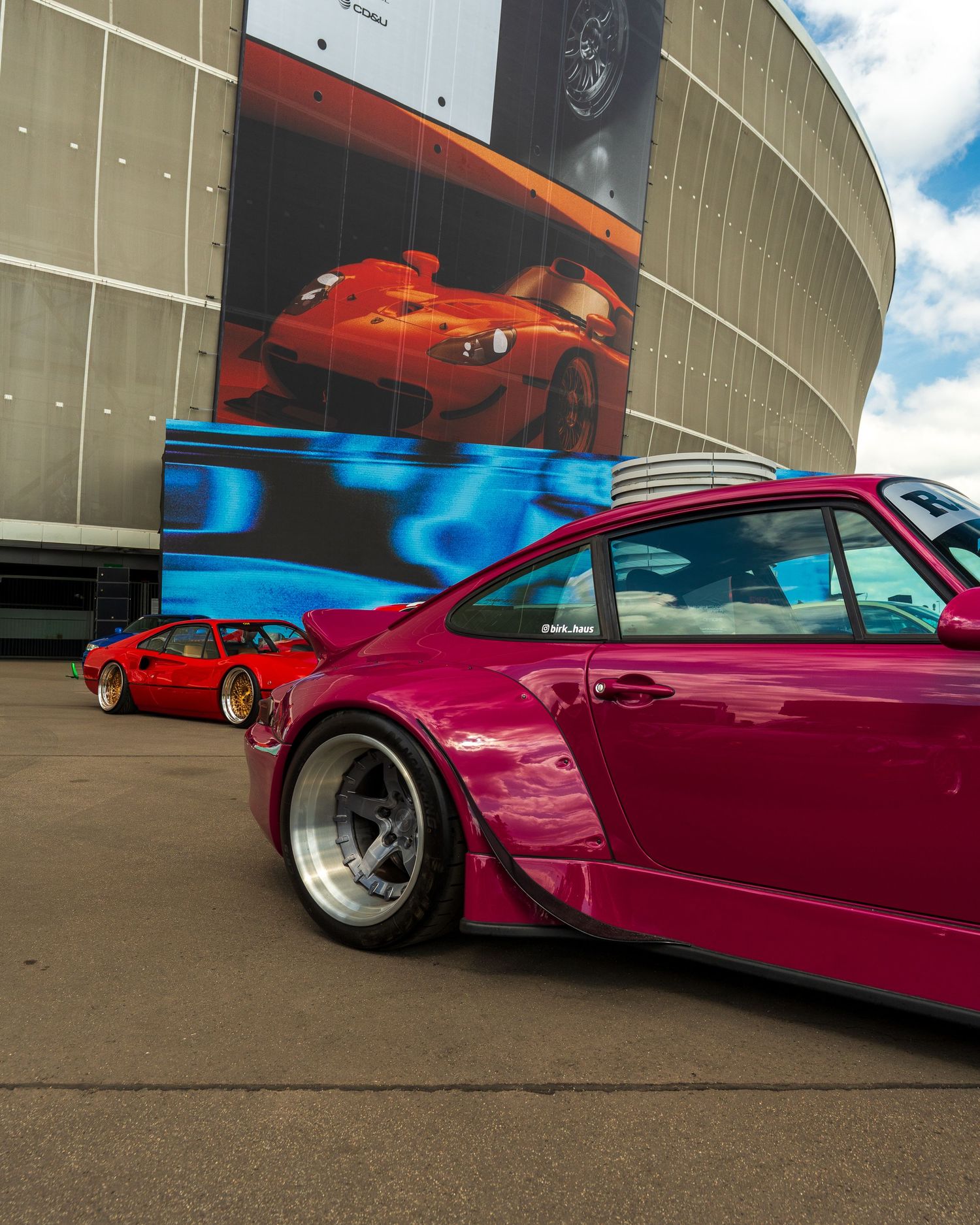 Custom magenta sports car with wide body kit and aftermarket wheels shown from various angles.