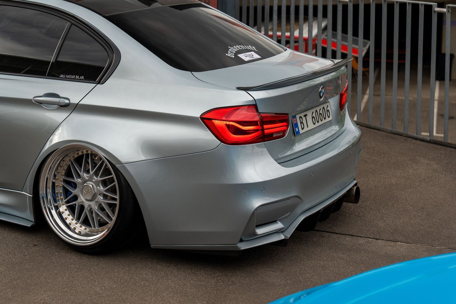 Modified BMW sedan showcasing lowered suspension and custom wheels.