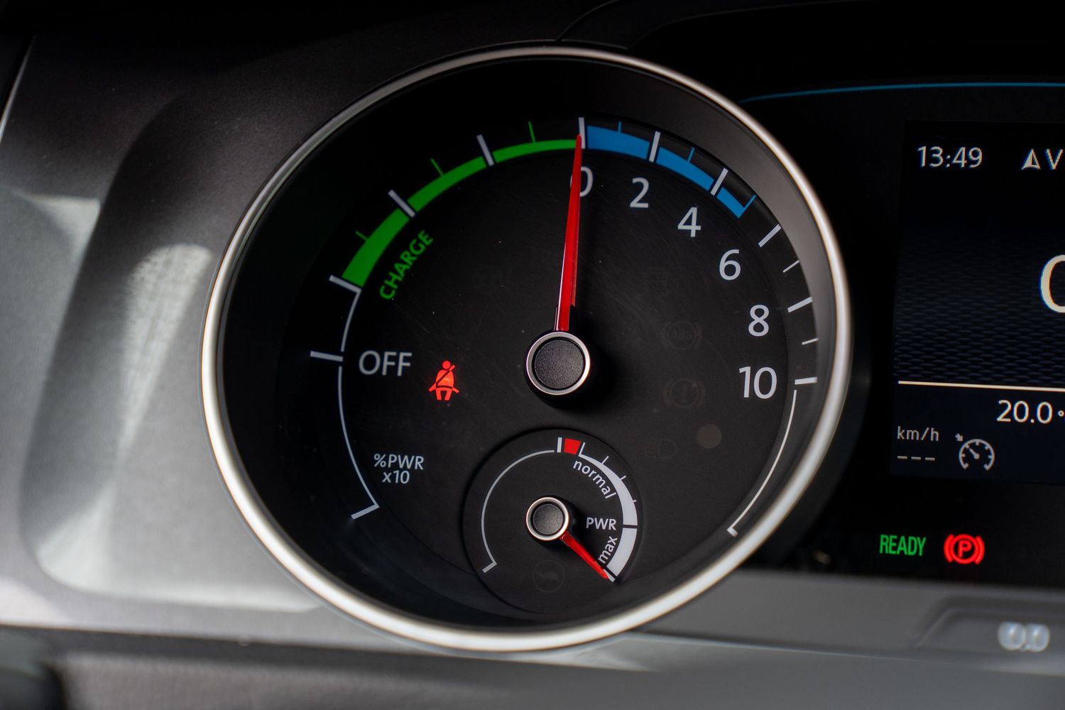 Modern car dashboard displaying a circular gauge with green eco mode indicator and digital readout.