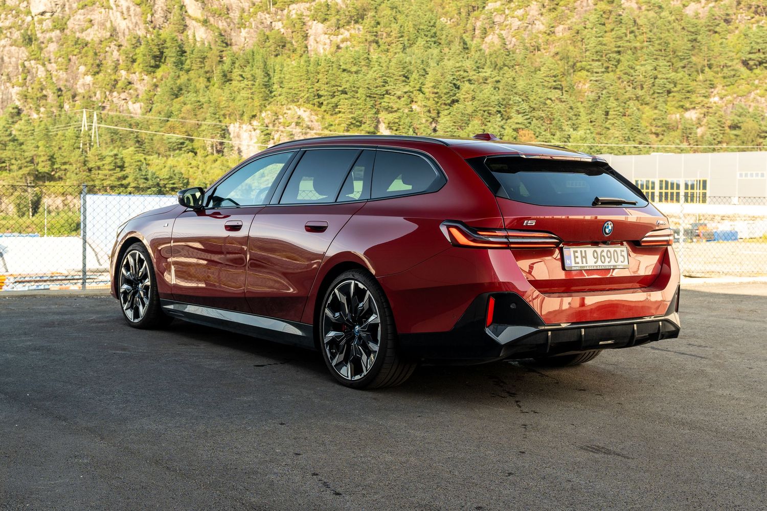 BMW M850i Gran Coupe's elegant silhouette captured against a scenic mountain landscape.