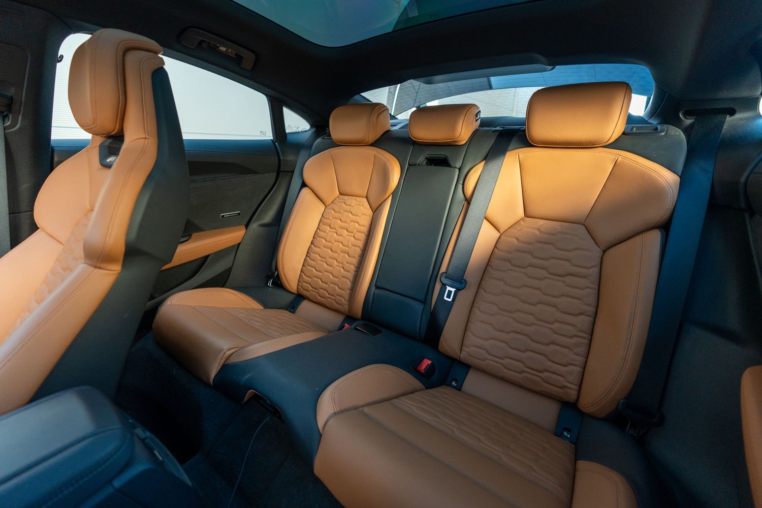 Premium tan leather rear seats in an Audi luxury vehicle.