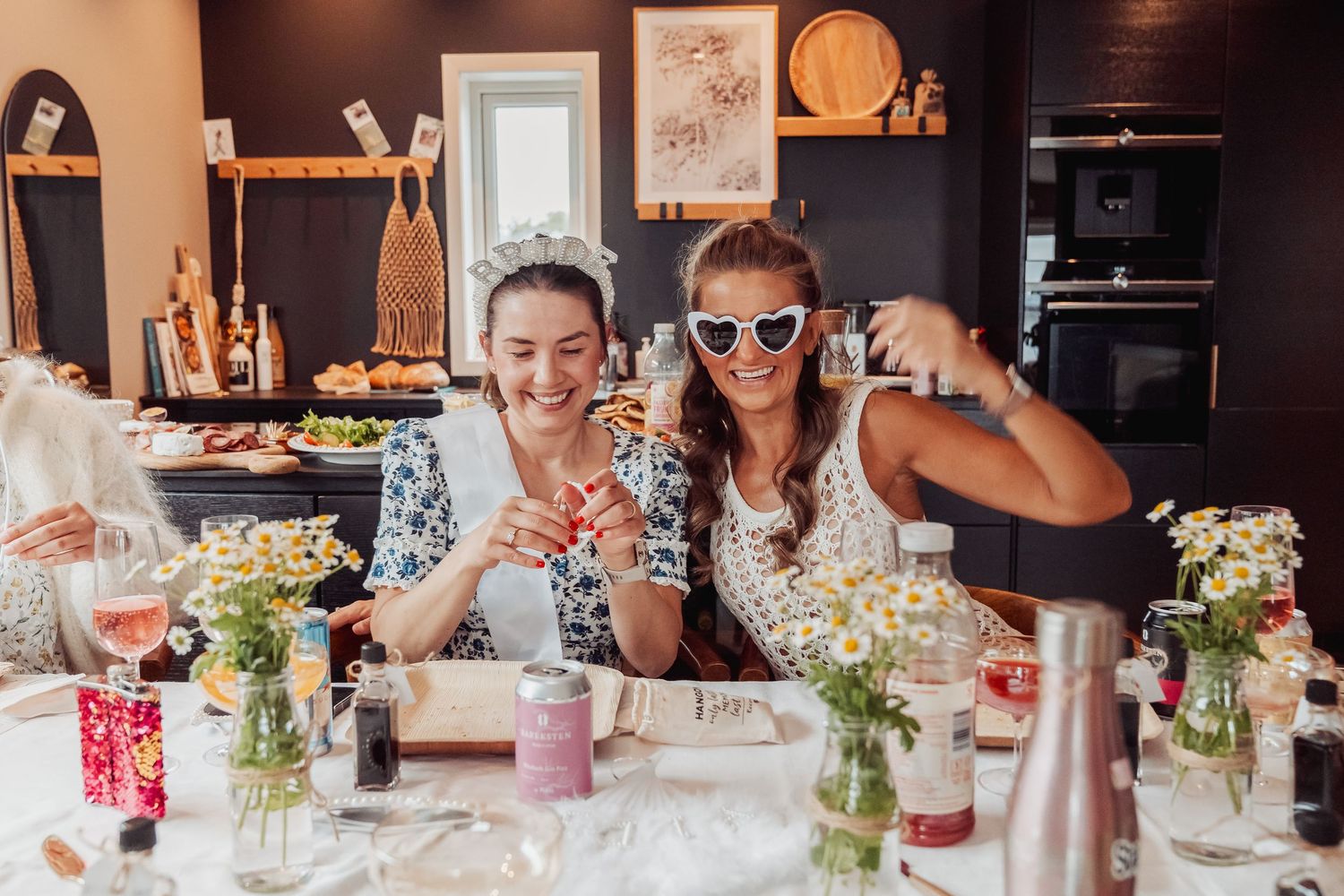 A bridal celebration with decorated table settings and floral centerpieces.