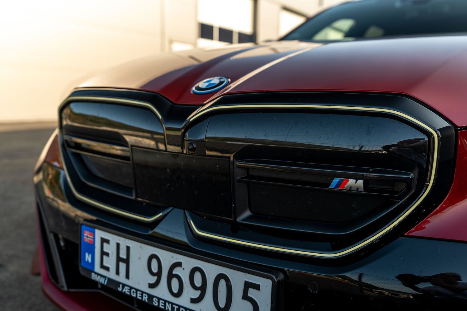 Close-up of BMW M-series front grille with signature black kidney design and European license plate.