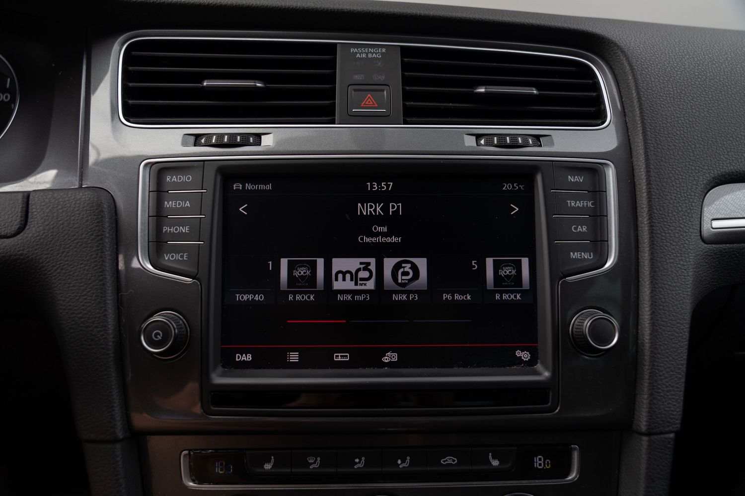 Modern car interior dashboard with climate control system and infotainment display.