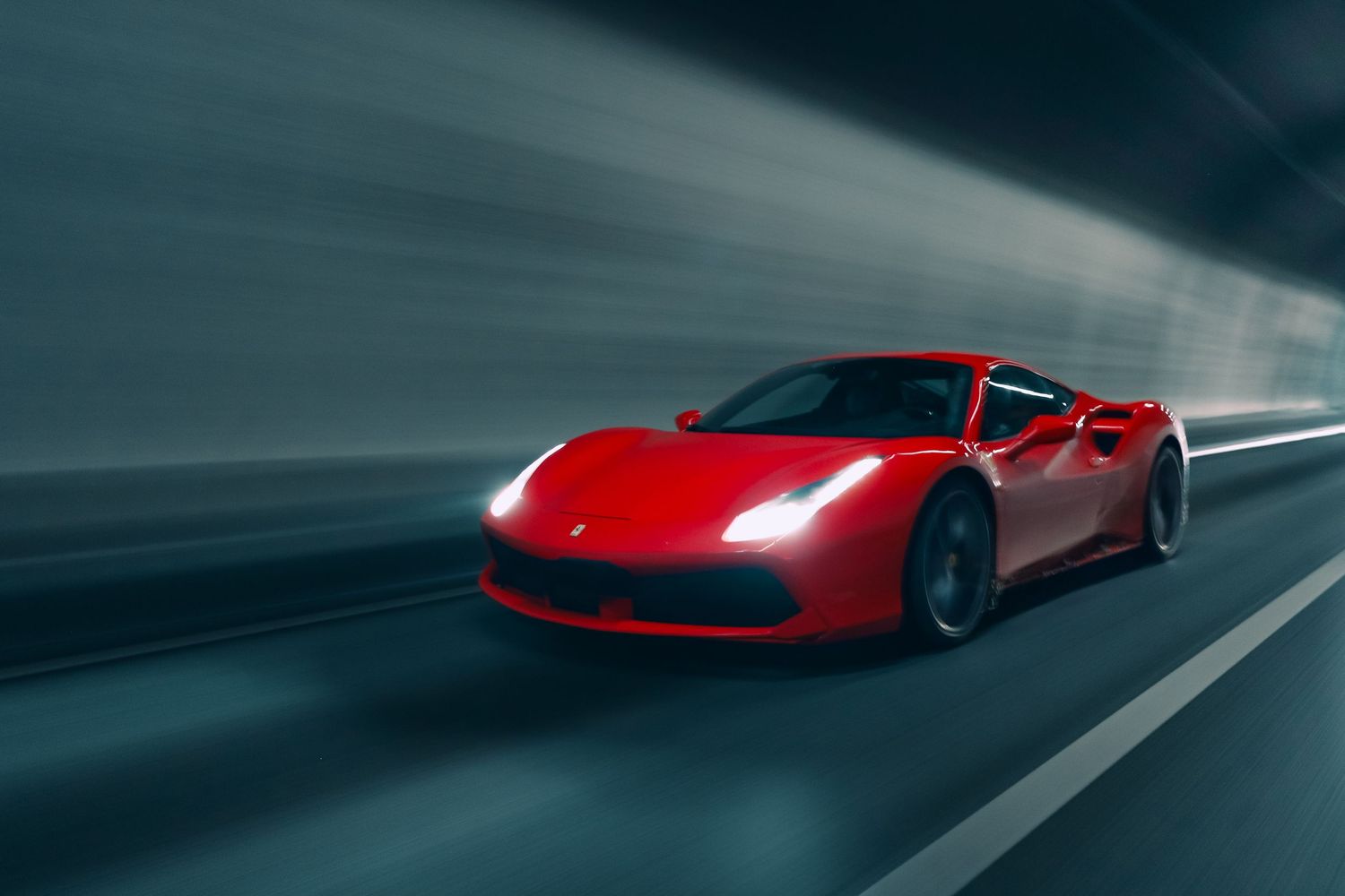 Red Ferrari 488 GTB speeding through tunnel with motion blur effect.