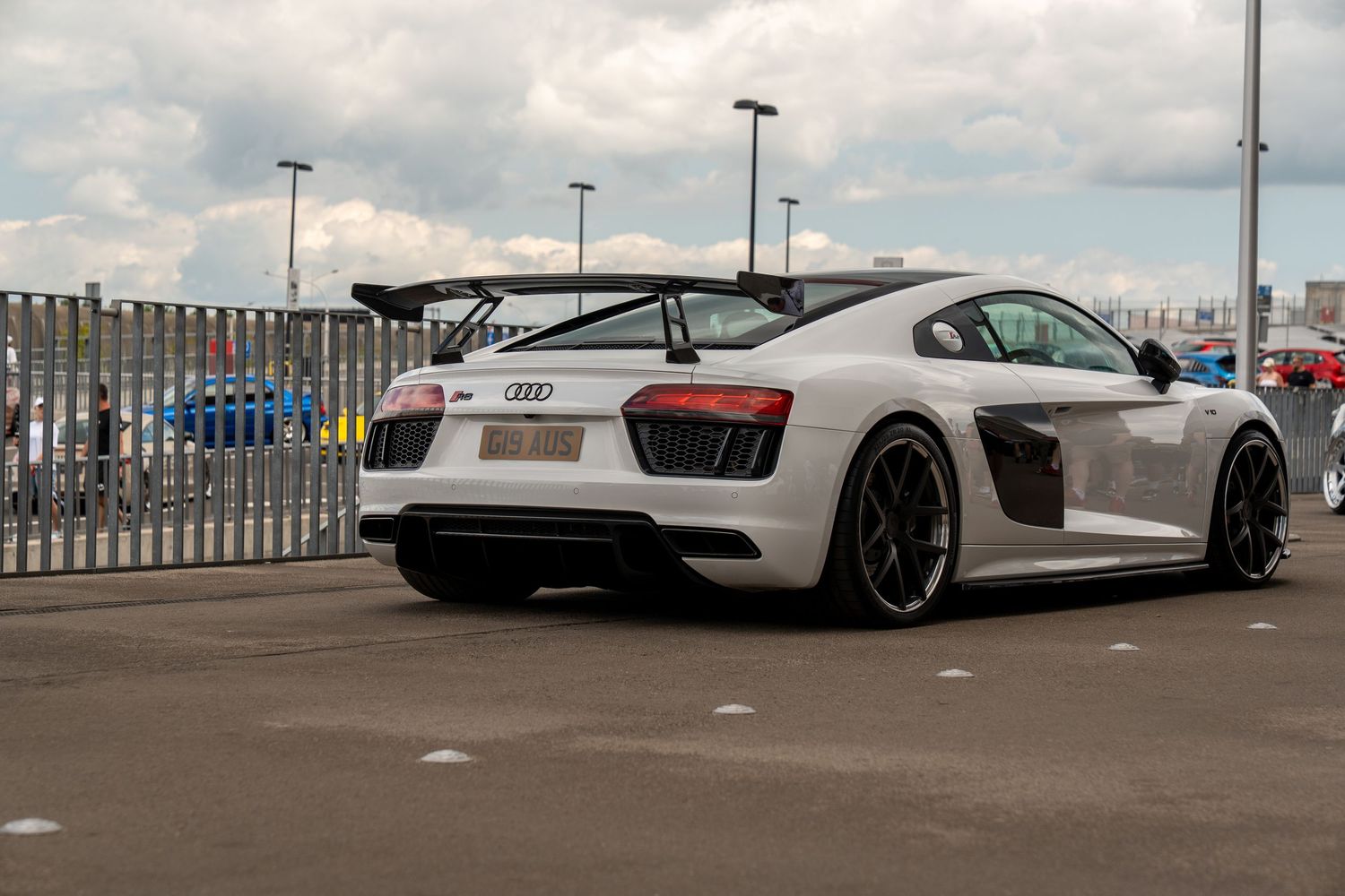 White and grey supercars lined up at a modern automotive showcase event.