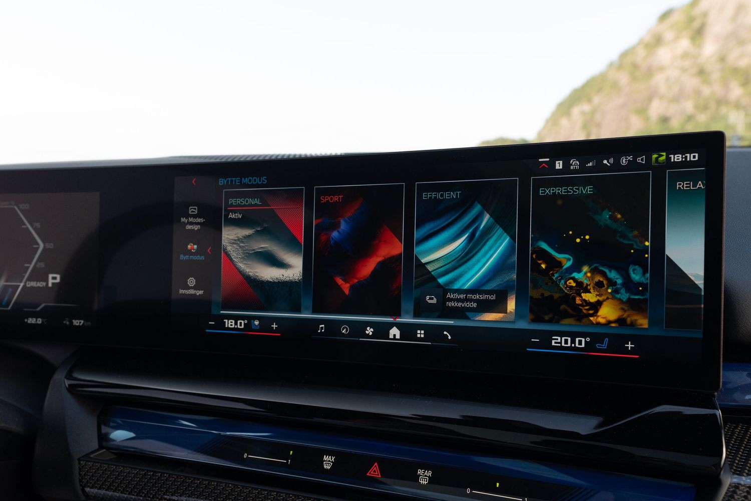 Wide digital display panel in a car dashboard showing vehicle settings and information.