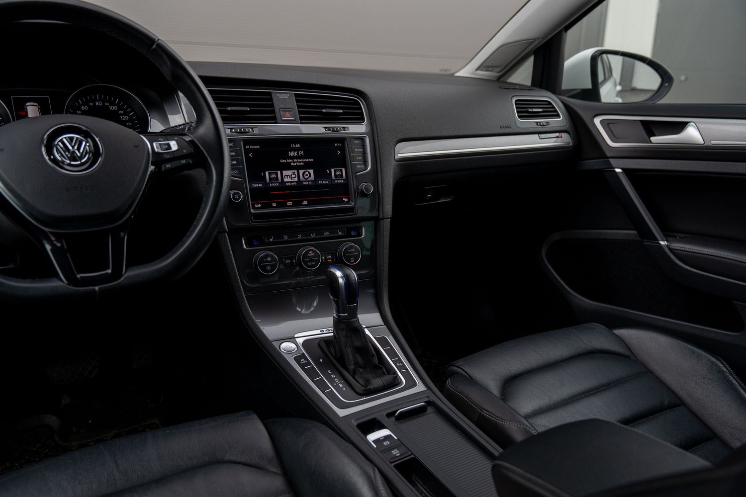 Interior view of modern vehicle dashboard showing infotainment system and digital instrument cluster.
