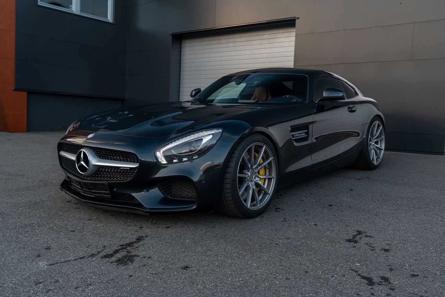 Mercedes-AMG GT in metallic black finish showcasing its sleek sports car profile. gen