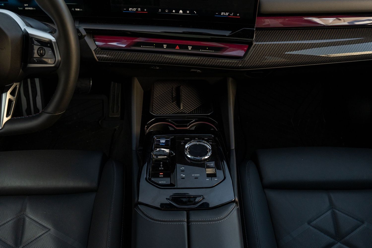 Luxury vehicle center console with black leather trim and rotary control interface.
