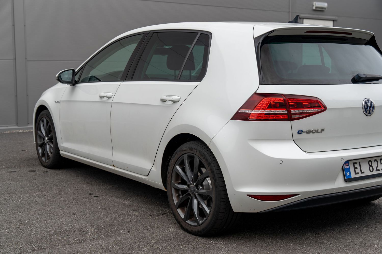 Multiple views of white Volkswagen Golf wagon's rear design and LED taillights.