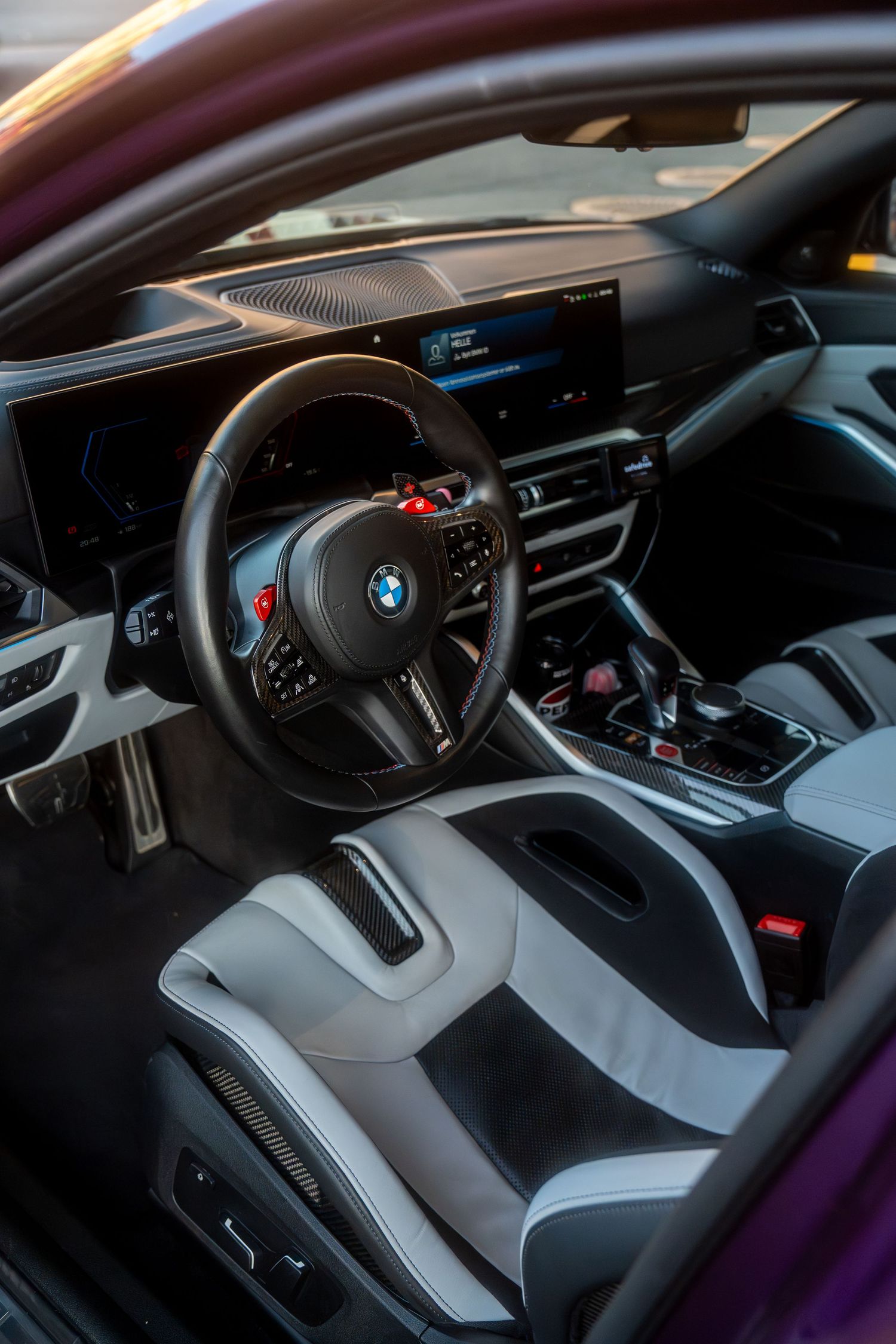 Sleek black and gray BMW interior showcasing modern dashboard design and sporty steering wheel controls.