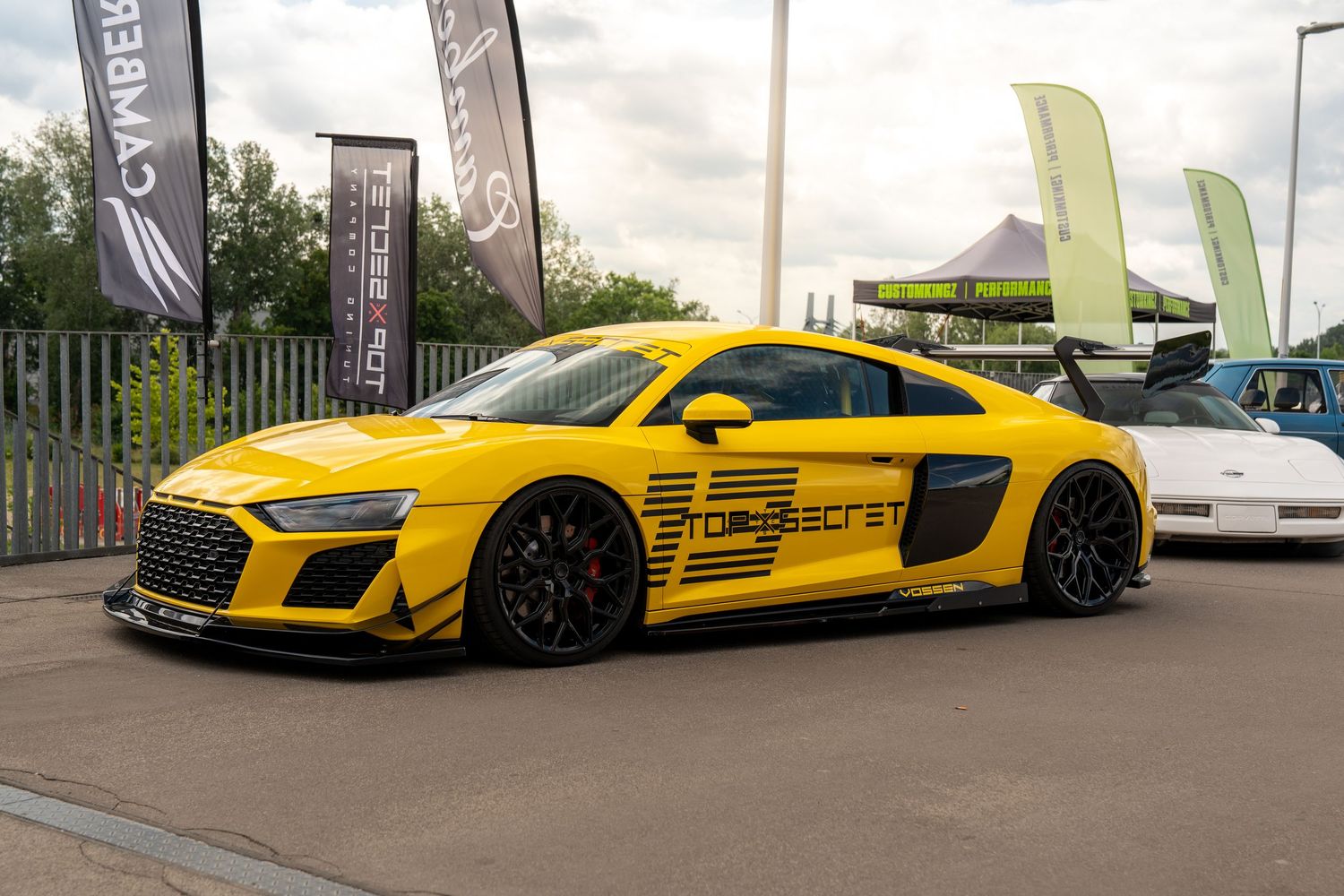 Yellow modified Audi R8 sports car with black accents and racing graphics.
